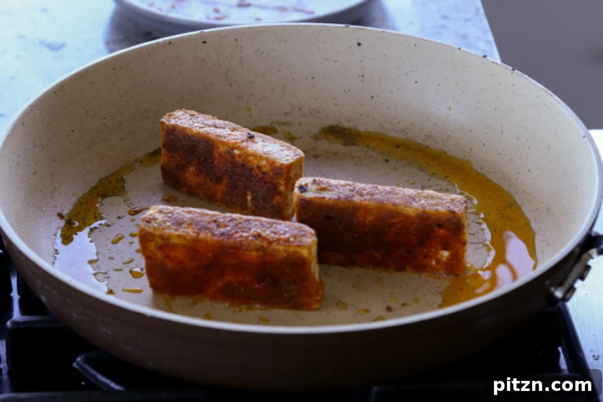 Vegan Marry Me Chicken Pasta 10 Seared tofu cooking in a hot skillet until golden and crispy