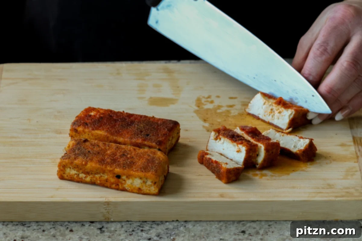 Vegan Marry Me Chicken Pasta 11 Slicing crispy pan-seared tofu into strips for the pasta