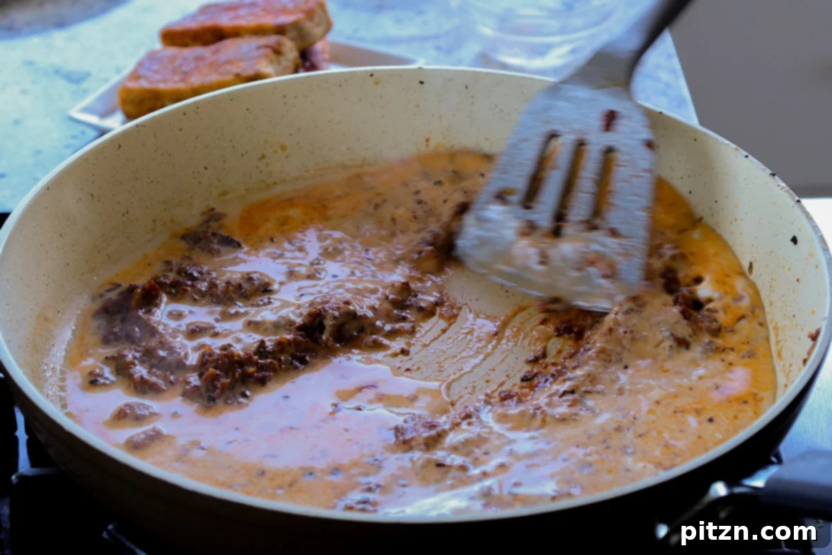 Vegan Marry Me Chicken Pasta 18 Pouring the remaining non-dairy milk into the simmering sauce