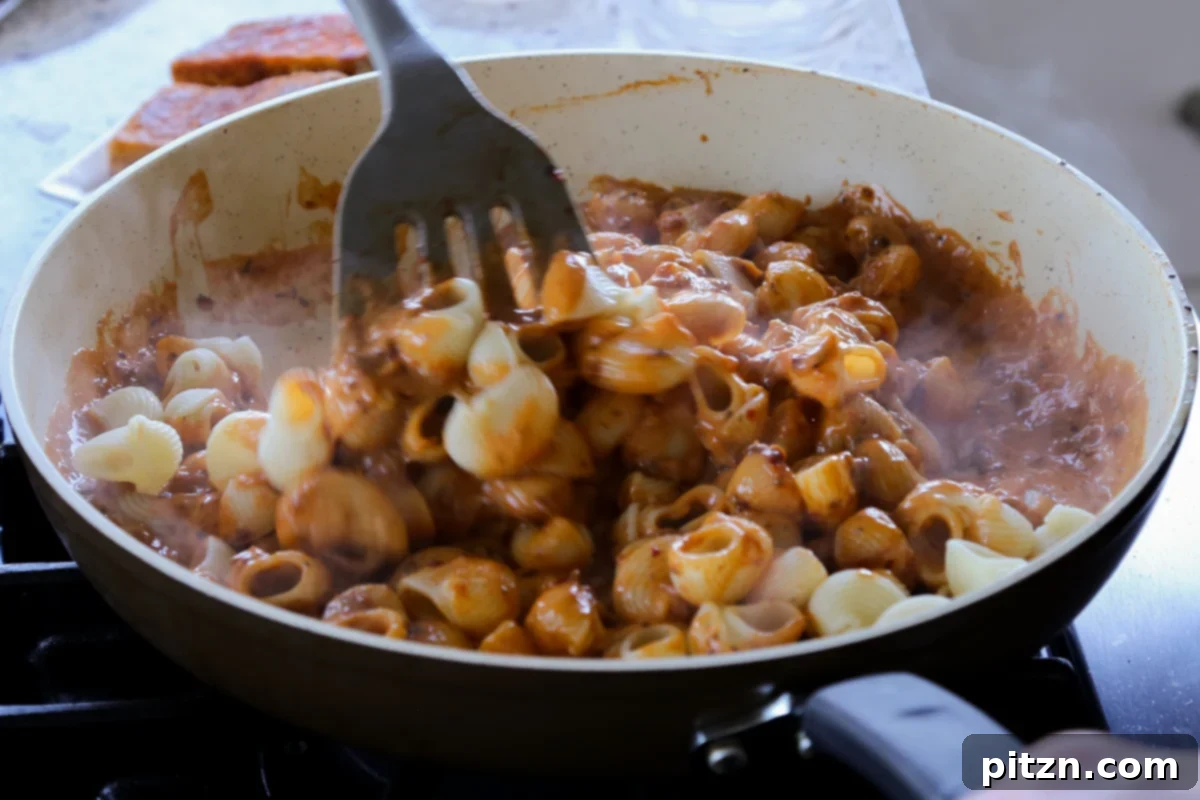Vegan Marry Me Chicken Pasta 22 Folding the pasta into the creamy sauce, ensuring every piece is coated