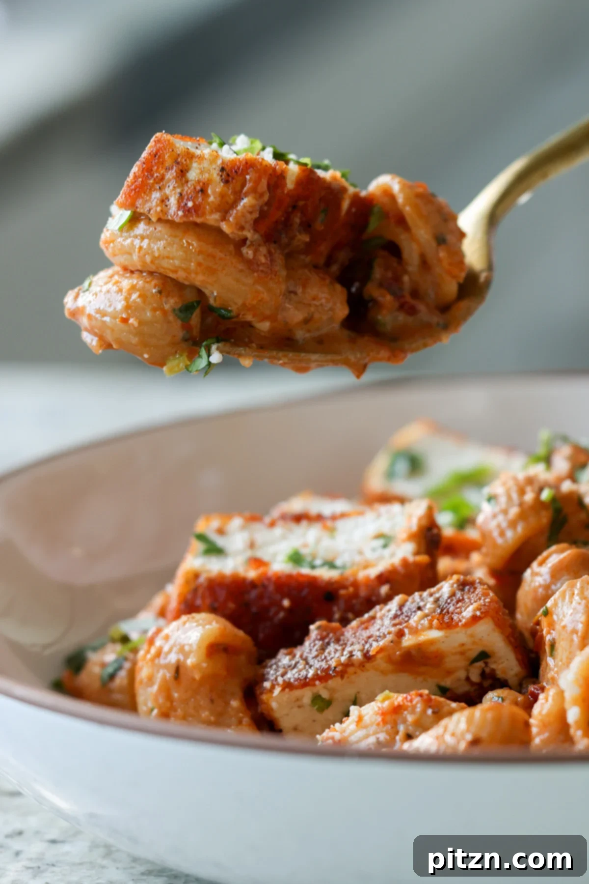 Vegan Marry Me Chicken Pasta 4 Fork taking a bite of creamy vegan marry me pasta with tofu