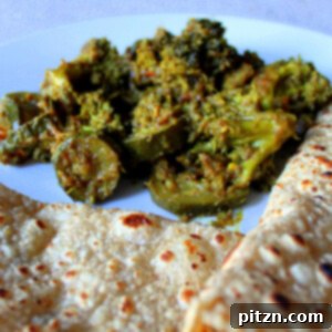 Broccoli and Zucchini in Onion and Pickle Spices served on a plate with roti