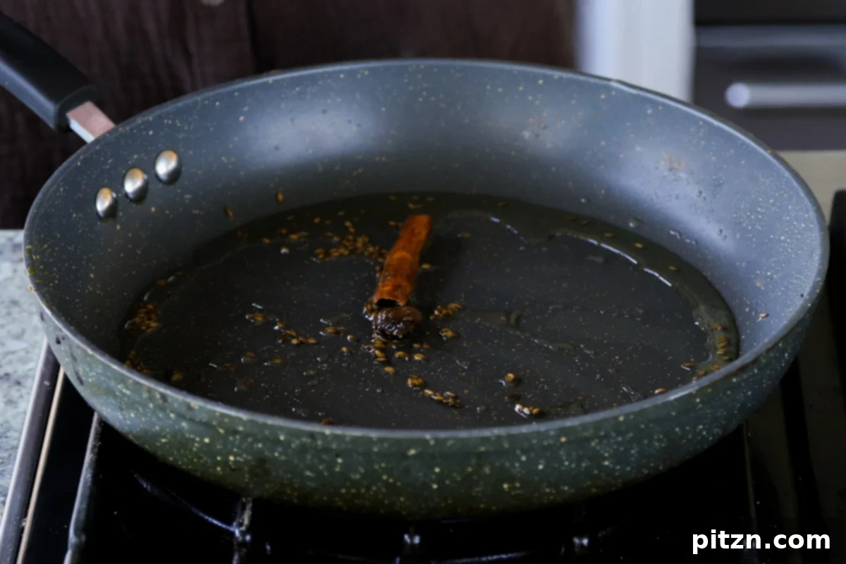 North Indian Smoky Rara Chicken Curry 18 adding more whole spices to the toasted cumin seeds in the pan