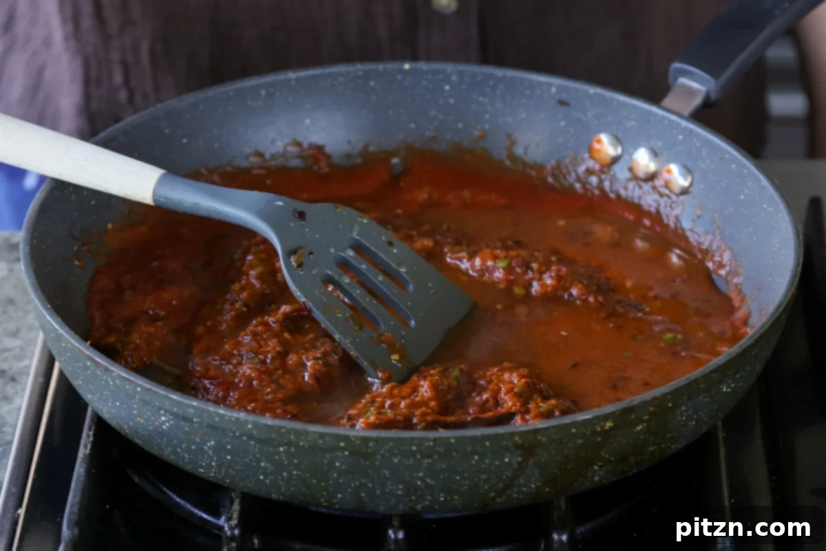 North Indian Smoky Rara Chicken Curry 24 mixing in the tomato puree
