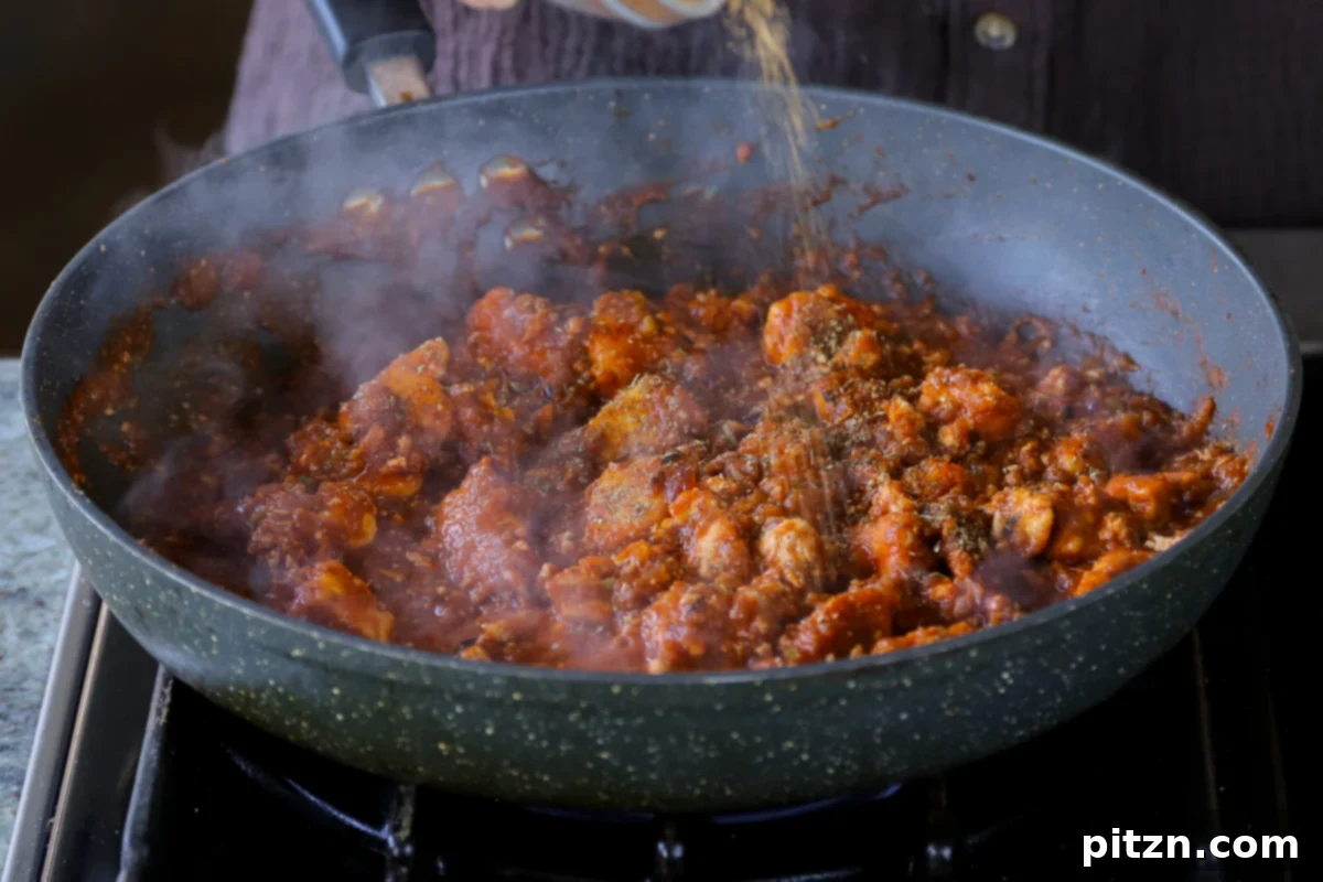 North Indian Smoky Rara Chicken Curry 28 adding more spices to the rara chicken curry sauce with tofu