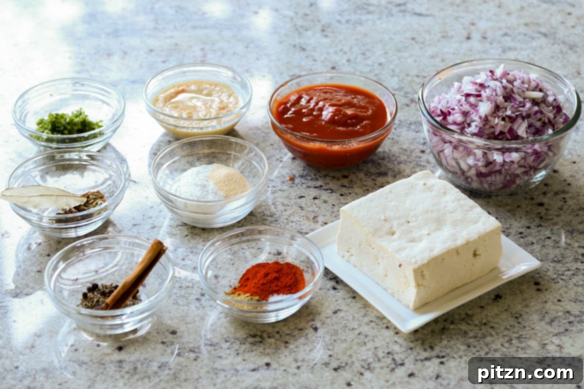 North Indian Smoky Rara Chicken Curry 7 rara chicken curry ingredients in bowls on the kitchen counter