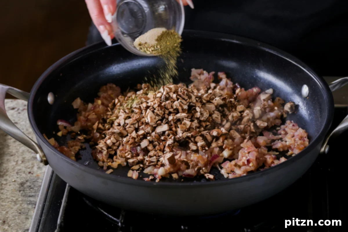 Weeknight Skillet Sausage and White Bean Pasta 10 Adding a selection of aromatic spices, including Italian herbs and fennel seeds, to the mushrooms and aromatics in the pan.