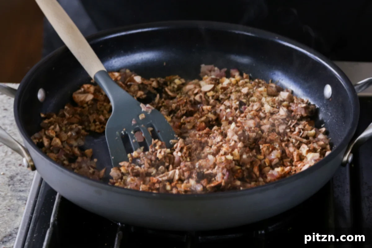 Weeknight Skillet Sausage and White Bean Pasta 13 Thoroughly mixing the mushroom, walnut, and spice mixture in the pan until well combined, creating the savory vegan sausage crumble.