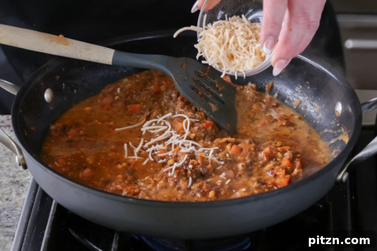 Weeknight Skillet Sausage and White Bean Pasta 17 Sprinkling vegan parmesan cheese into the simmering vegan sausage pasta sauce to enhance its richness and creaminess.