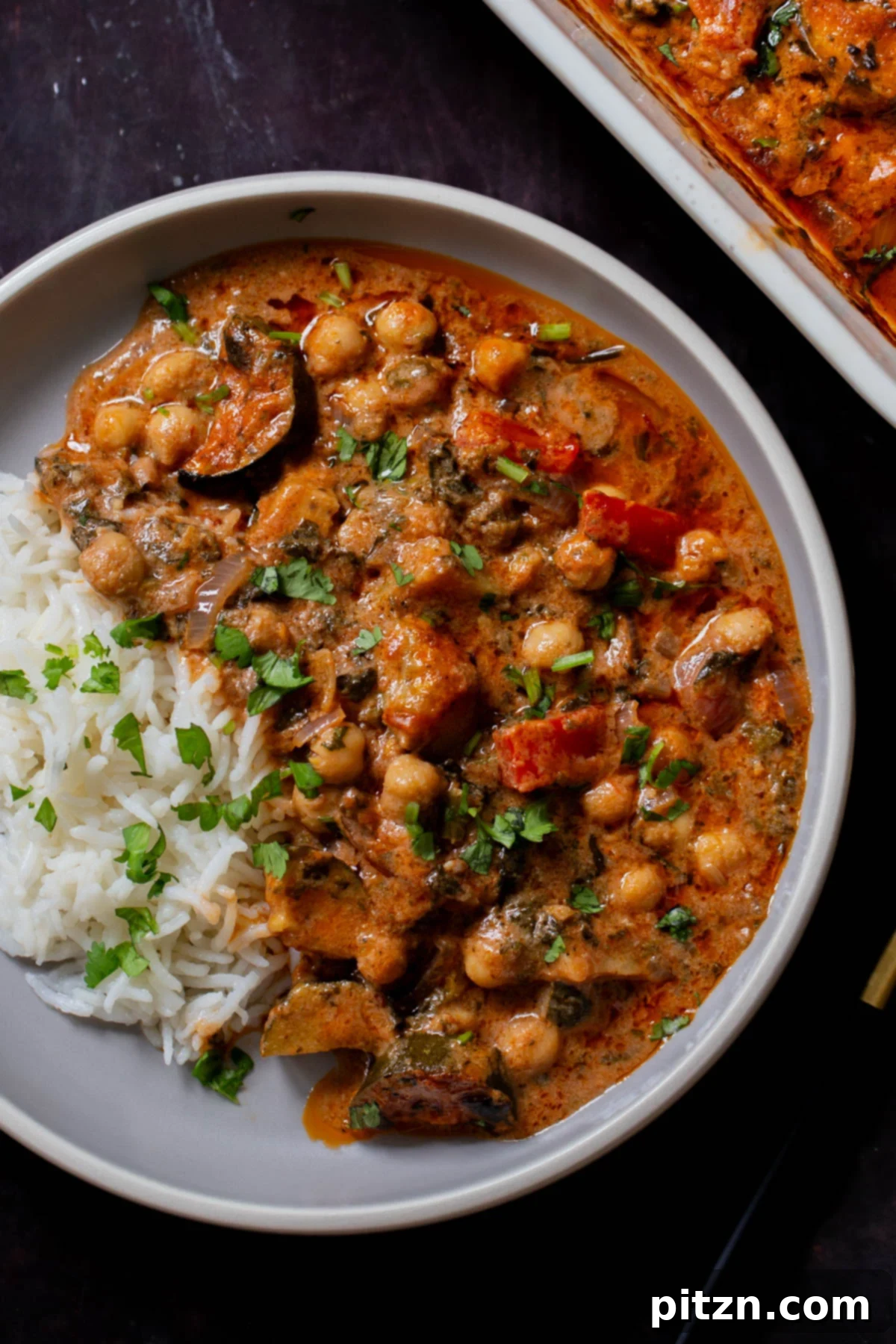 Spicy Golden Baked Zucchini Chickpea Curry Allergen Free 2 Delicious baked zucchini chickpea curry served in a bowl with fluffy rice, ready to eat.