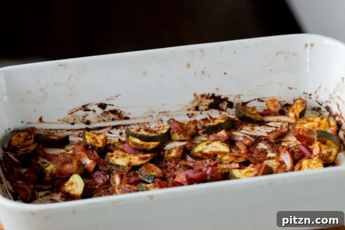 Spicy Golden Baked Zucchini Chickpea Curry Allergen Free 10 Roasted zucchini and onions after the initial bake, having developed a slight caramelization.