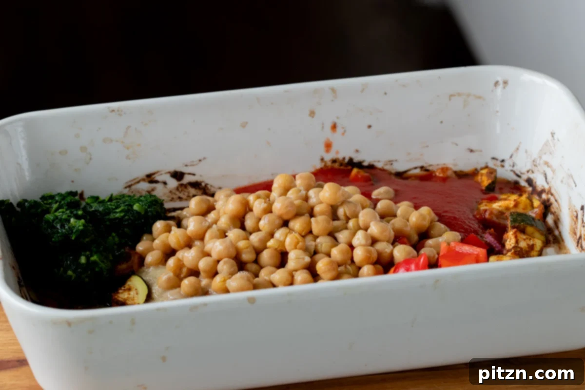 Spicy Golden Baked Zucchini Chickpea Curry Allergen Free 12 Drained chickpeas being added to the pan with the partially cooked vegetables and aromatics.