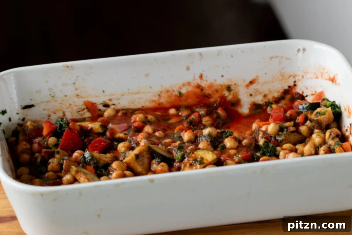 Spicy Golden Baked Zucchini Chickpea Curry Allergen Free 13 Tomato paste thoroughly mixed into the roasted vegetables, creating a rich red base.