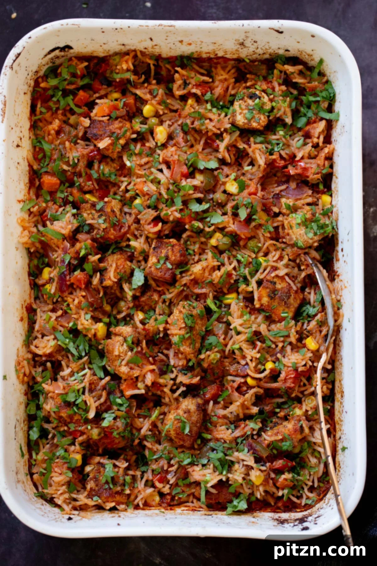 Fragrant Tikka Masala Rice Bake with Golden Crispy Tofu 21 A wide shot of the Tikka Masala Rice Bake in its ceramic dish after baking and fluffing, showcasing its enticing texture and presentation.