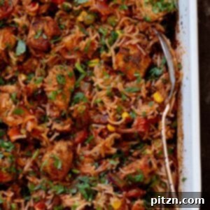 Close-up view of the baked Tikka Masala Rice in the pan, showing fluffy grains and seasoned tofu.