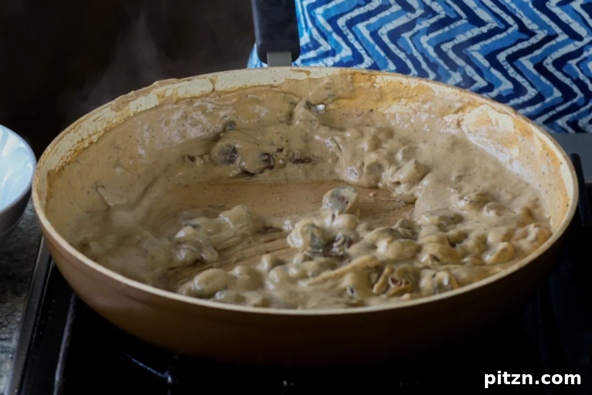 The fully thickened and cooled mushroom cream sauce in the pan, ready for puff pastry assembly.