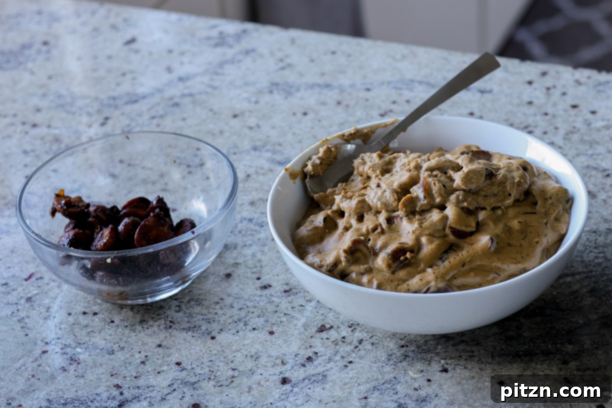 A bowl of sautéed mushrooms next to a bowl of creamy mushrooms after cooling, both components ready for the puffs.