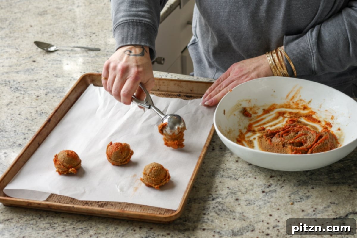 Allergy Friendly Gochujang Caramel Cookies 13 scooping gochujang caramel cookies onto the parchment-lined cookie sheet
