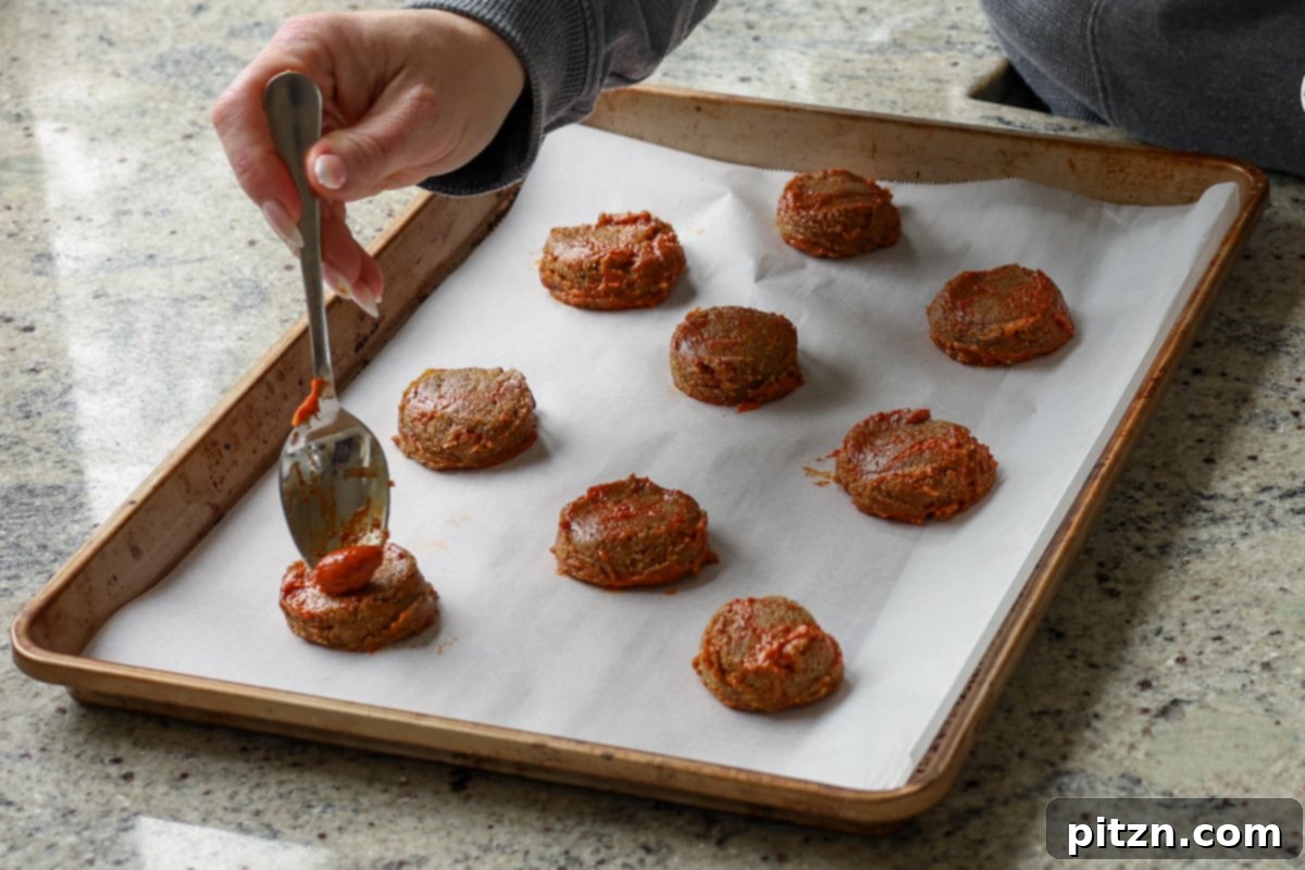 Allergy Friendly Gochujang Caramel Cookies 14 swirling on extra gochujang caramel onto scooped cookie dough