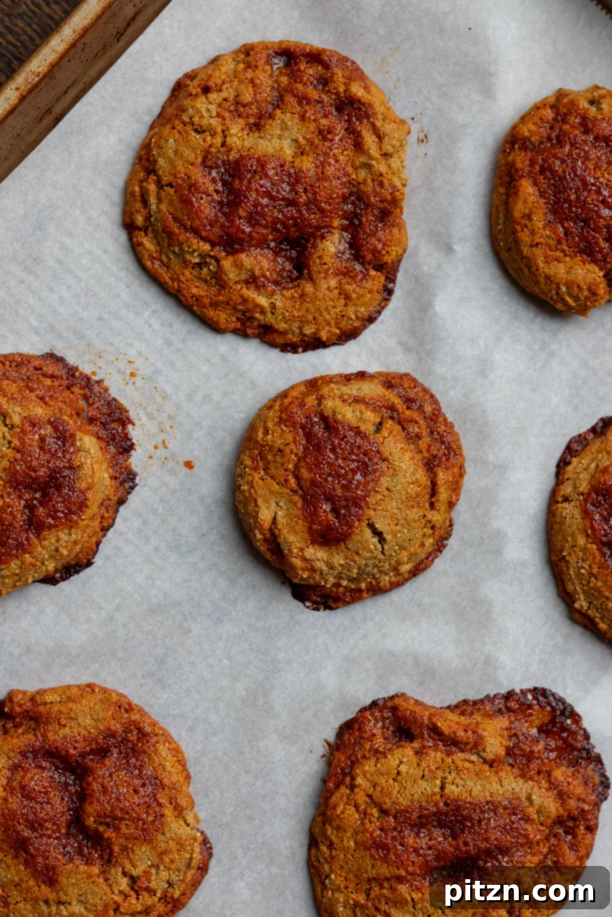 Allergy Friendly Gochujang Caramel Cookies 4 gochujang caramel cookies cooling on a baking sheet, ready to be enjoyed