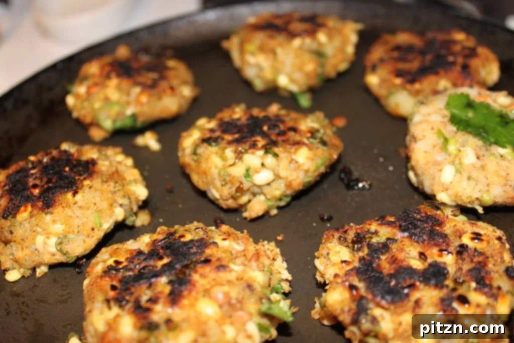 Wholesome Sprout Potato Burgers 2 Delicious and healthy Sprouts Potato Cutlets on a platter, garnished with fresh herbs, ready to be served as vegan burger patties.