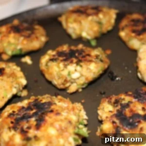 Wholesome Sprout Potato Burgers 4 Crispy golden brown Sprouts Potato Cutlets served on a dark plate, ready to be enjoyed.