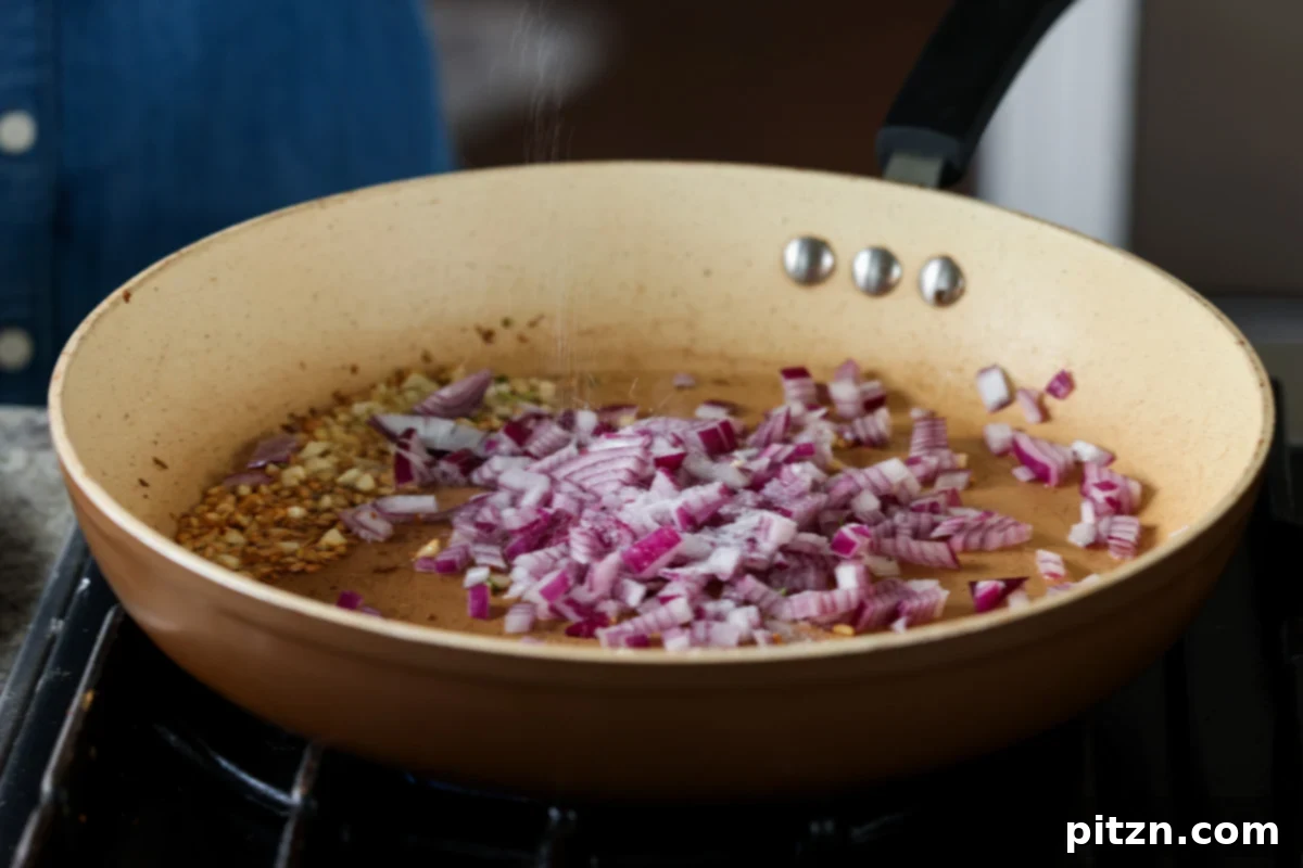 Golden Paprika Tofu with Creamy Garlic Parmesan Orzo 15 Adding chopped onion to the skillet with the fragrant cooked garlic.