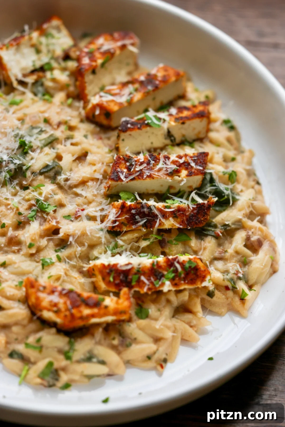 Golden Paprika Tofu with Creamy Garlic Parmesan Orzo 3 A large pan filled with creamy garlic parmesan orzo, ready to be served.