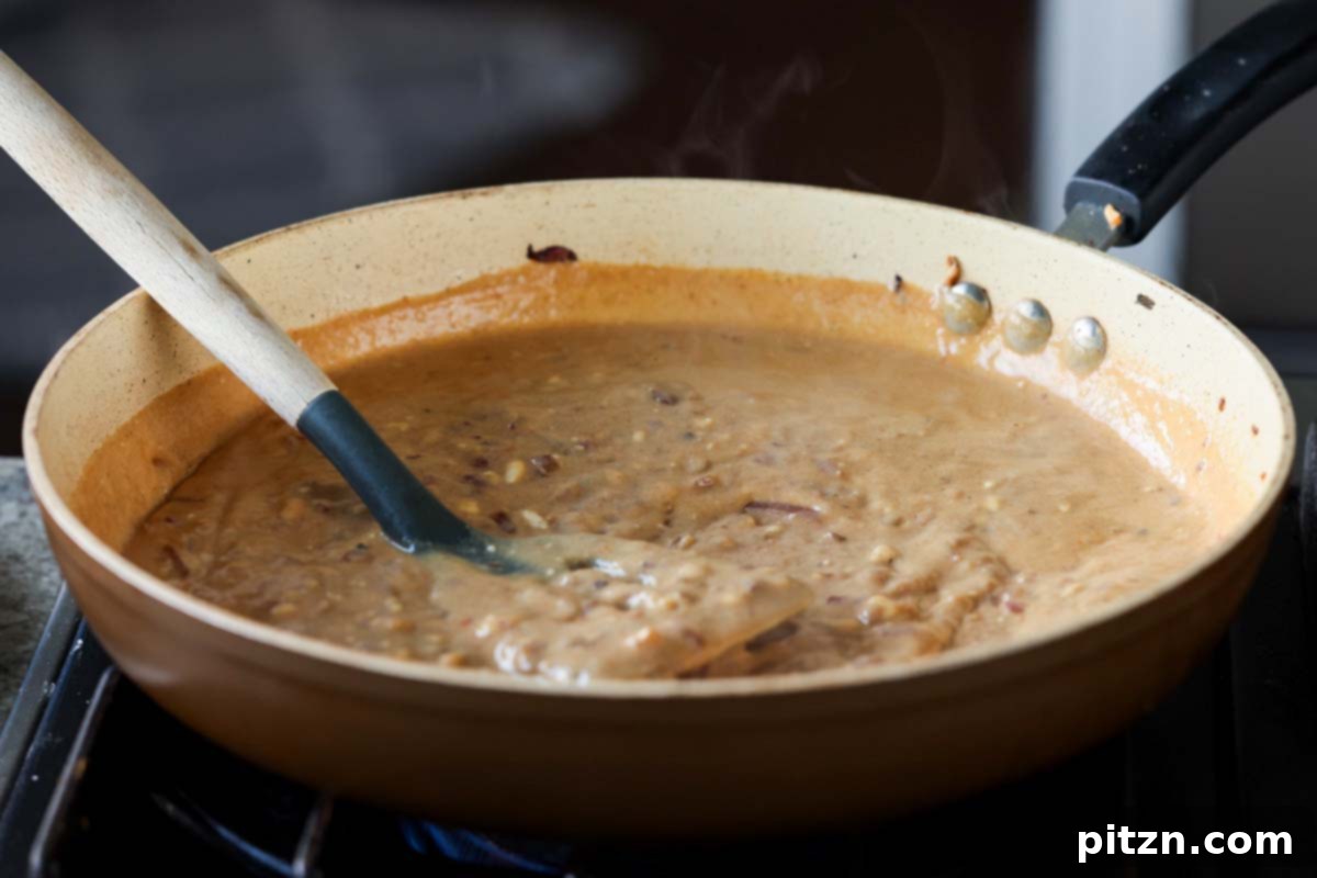 Golden Paprika Tofu with Creamy Garlic Parmesan Orzo 22 A rich and bubbly garlic parmesan sauce simmering in the pan.