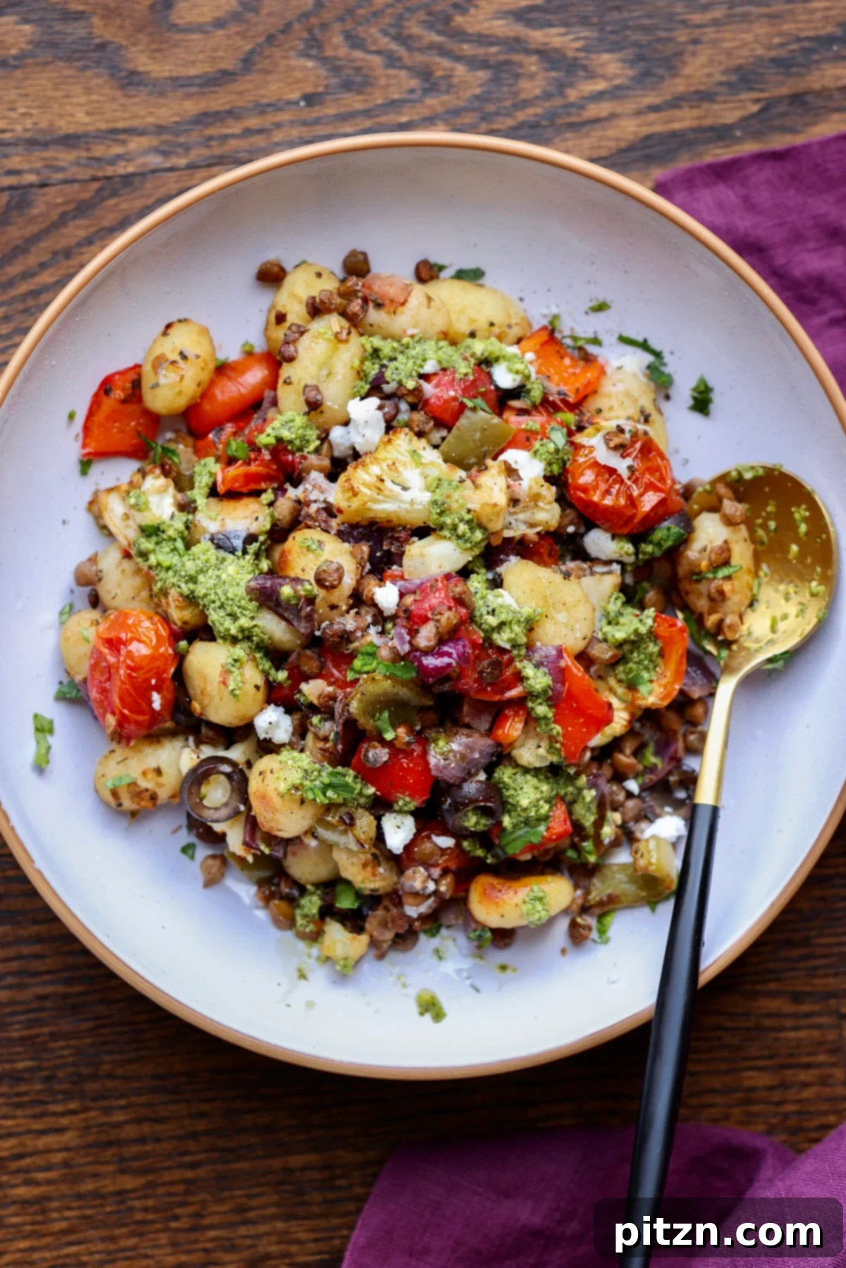 One-Pan Mediterranean Gnocchi: No Boil, Big Flavor 2 Crispy Sheet Pan Gnocchi with roasted cherry tomatoes, bell peppers, and fresh basil, served in a bowl.