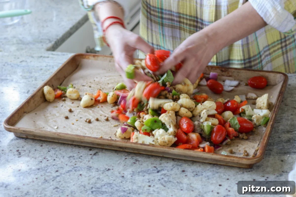 One-Pan Mediterranean Gnocchi: No Boil, Big Flavor 11 The gnocchi and vegetable mixture spread evenly in a single layer on the baking sheet, ready for the oven.
