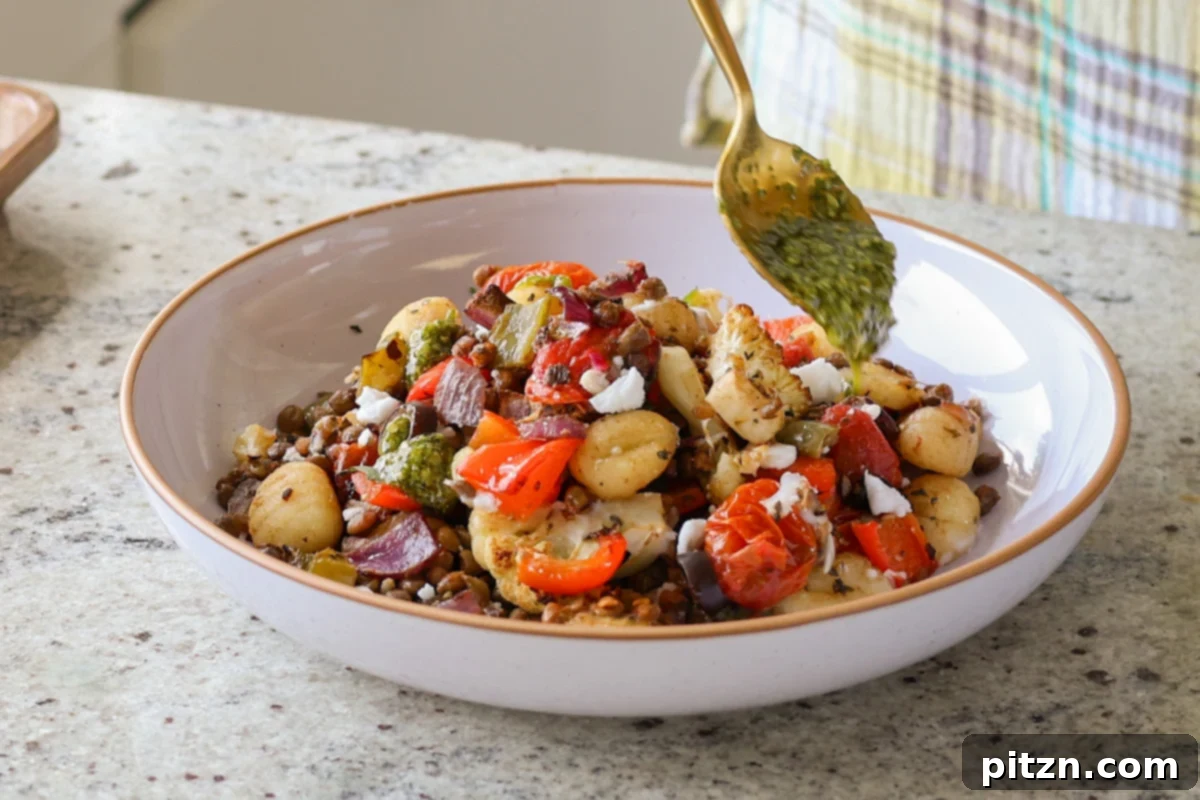 One-Pan Mediterranean Gnocchi: No Boil, Big Flavor 15 Adding a spoonful of vibrant green vegan pesto to a bowl of sheet pan gnocchi.