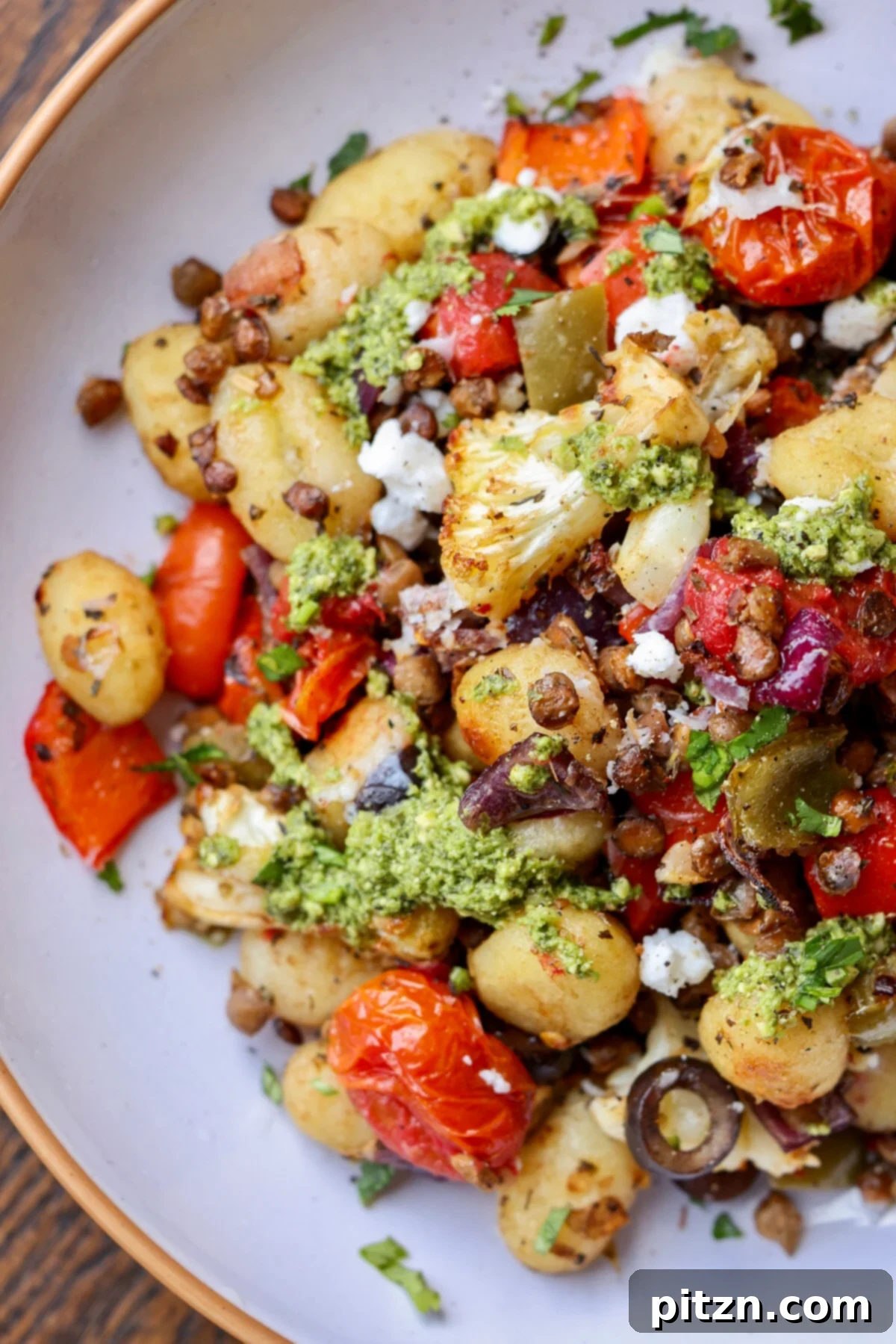 One-Pan Mediterranean Gnocchi: No Boil, Big Flavor 3 Close-up of roasted sheet pan gnocchi with colorful bell peppers, cherry tomatoes, and lentils in a balsamic herb sauce.