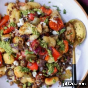 One-Pan Mediterranean Gnocchi: No Boil, Big Flavor 6 Sheet pan gnocchi in a bowl, ready to be served, garnished with fresh basil.