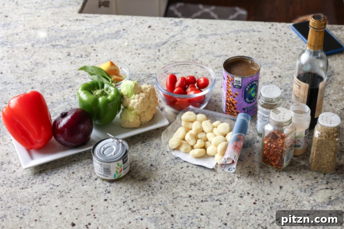 One-Pan Mediterranean Gnocchi: No Boil, Big Flavor 7 All the fresh ingredients for sheet pan gnocchi laid out on a wooden board: gnocchi, bell peppers, cherry tomatoes, lentils, onion, basil, and a bowl of seasoning mix.