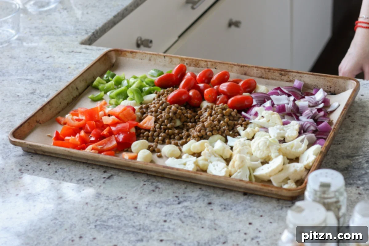 One-Pan Mediterranean Gnocchi: No Boil, Big Flavor 8 Gnocchi, lentils, and assorted chopped vegetables spread on a parchment-lined baking sheet before seasoning.