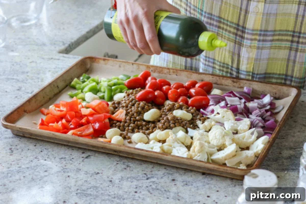 One-Pan Mediterranean Gnocchi: No Boil, Big Flavor 9 Olive oil and balsamic vinegar being drizzled over the gnocchi and vegetables on the baking sheet.