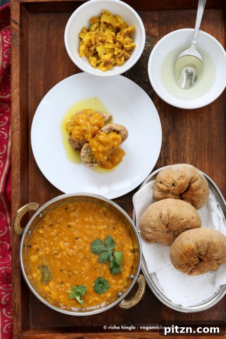 Plated Dal Baati meal with a view from above, highlighting the fresh garnishes.