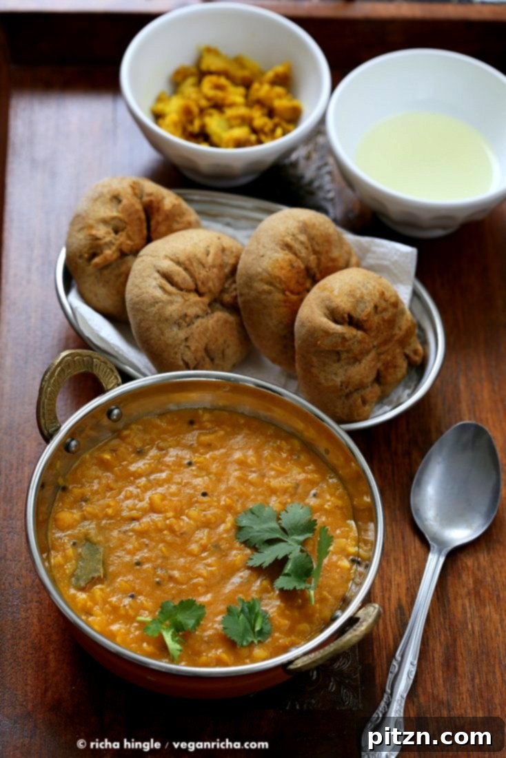 A close-up of a perfectly baked, golden-brown Baati, ready to be served.