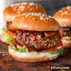 Three perfectly grilled black bean sunflower seed burgers on a rustic wooden cutting board, garnished with fresh herbs.