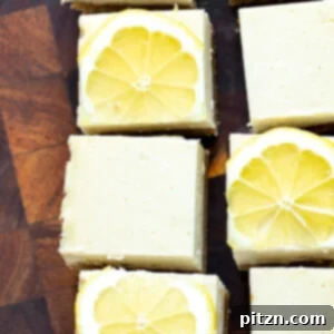Bright and tangy Vegan Lemon Bars, showcasing their golden crust and creamy lemon filling, dusted with powdered sugar. Gluten-free option.