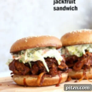 Close-up of a delicious Pulled Jackfruit Sandwich, showcasing the shredded texture and rich BBQ sauce.