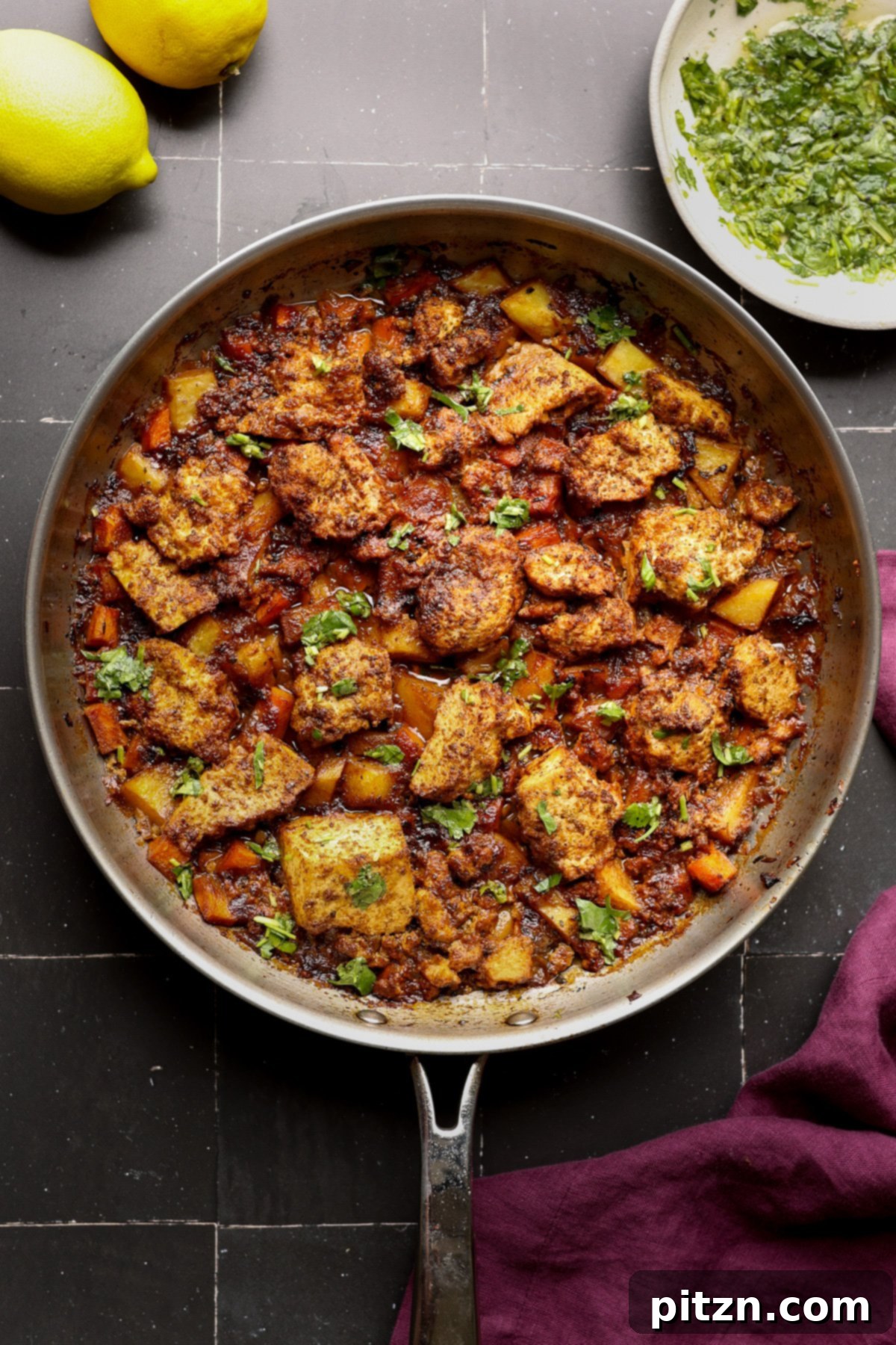 One Pan Chicken Style Braised Tofu and Vegetables 2 Flavorful braised tofu and mixed vegetables simmering in a savory sauce in an oven-safe pan, ready for serving.