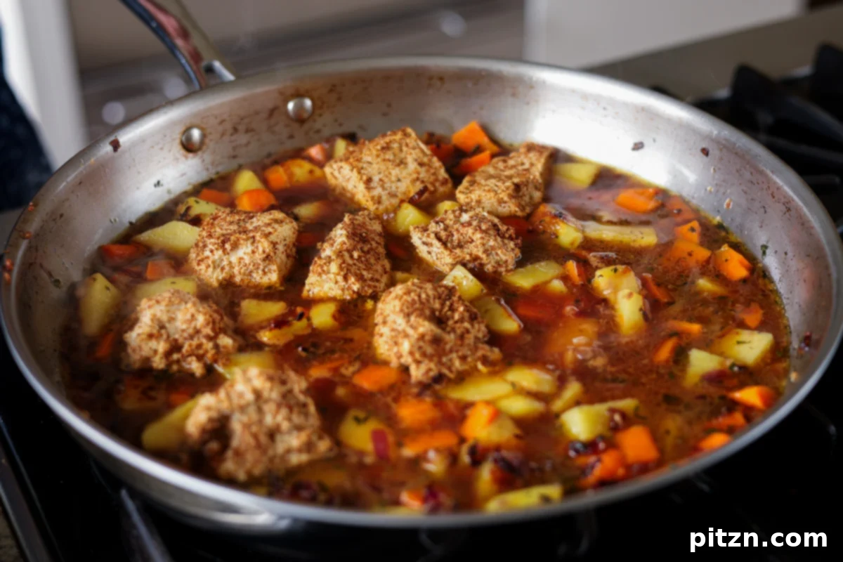 One Pan Chicken Style Braised Tofu and Vegetables 18 Tofu and vegetables arranged in the pan, now covered with the braising sauce, ready to be transferred to the oven.