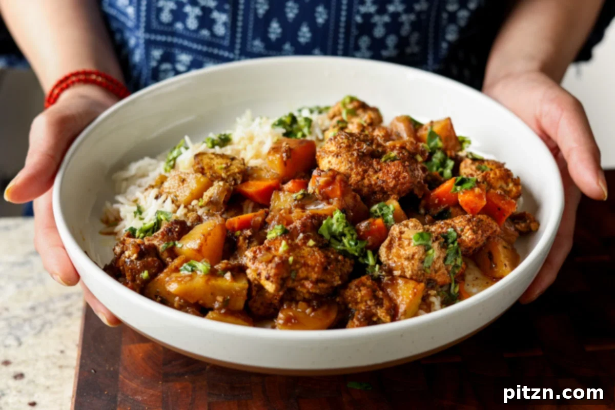One Pan Chicken Style Braised Tofu and Vegetables 22 A serving of braised tofu and vegetables in a bowl, accompanied by rice and a drizzle of fresh herb sauce, presented beautifully.