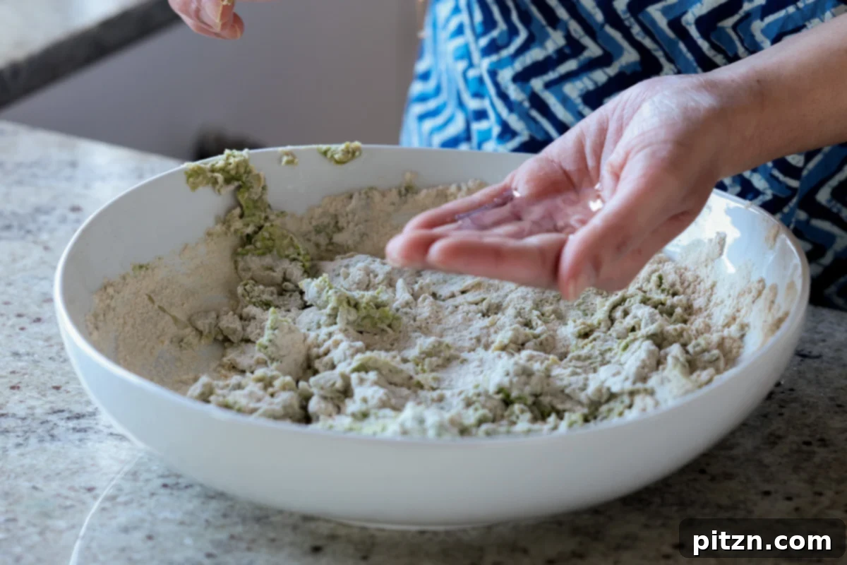 Yeast-Free Spinach Paratha Flatbread 14 Hands being oiled before beginning the kneading process for the spinach paratha dough.
