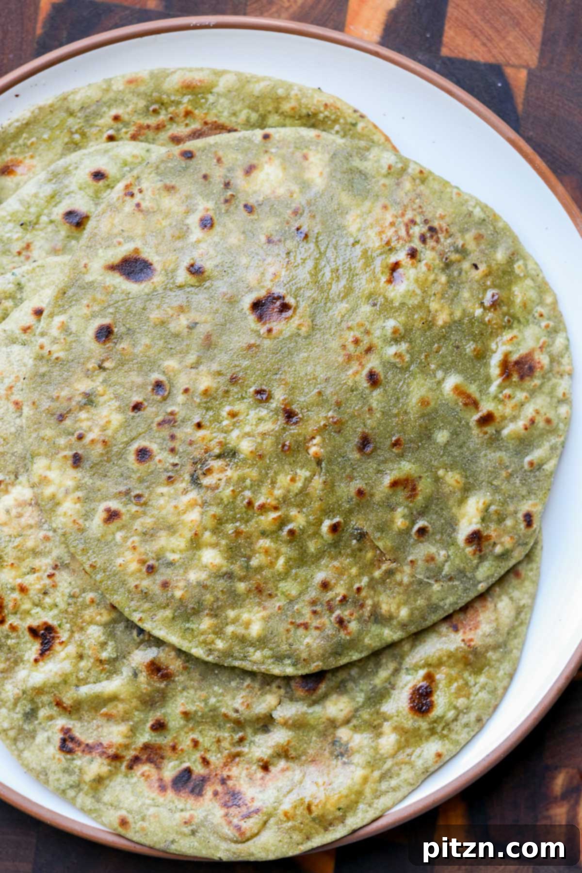 Yeast-Free Spinach Paratha Flatbread 3 A serving plate generously filled with freshly made spinach parathas, radiating warmth and home-cooked goodness.