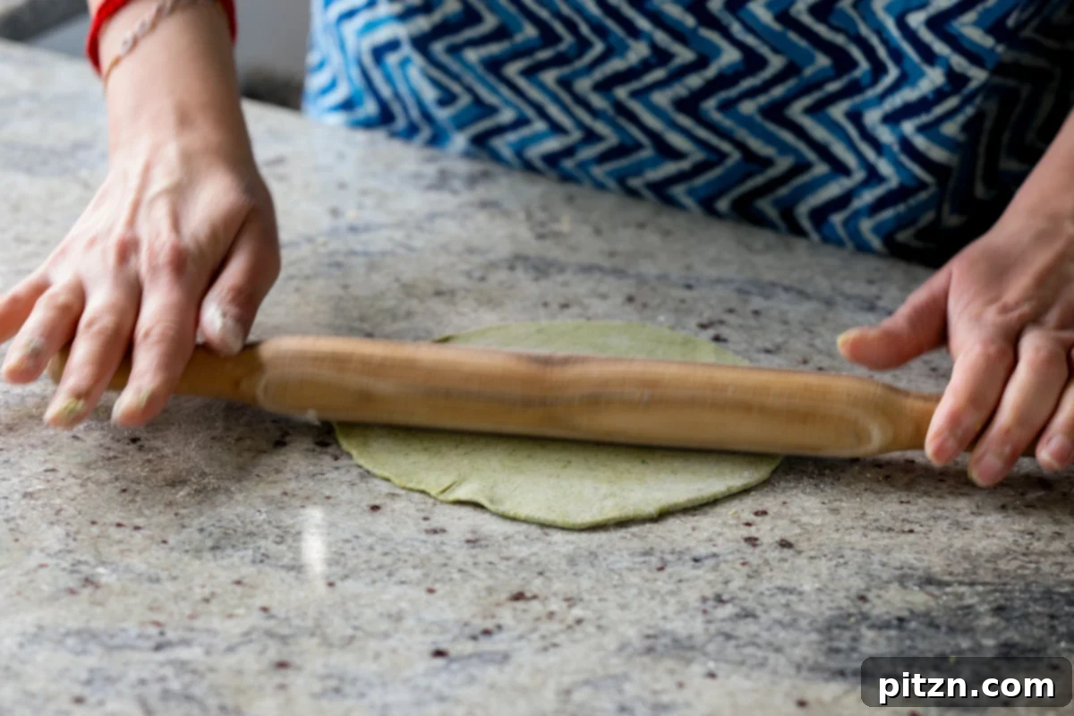 Yeast-Free Spinach Paratha Flatbread 23 A spinach paratha after being rolled out into a smooth, even circle on the counter.