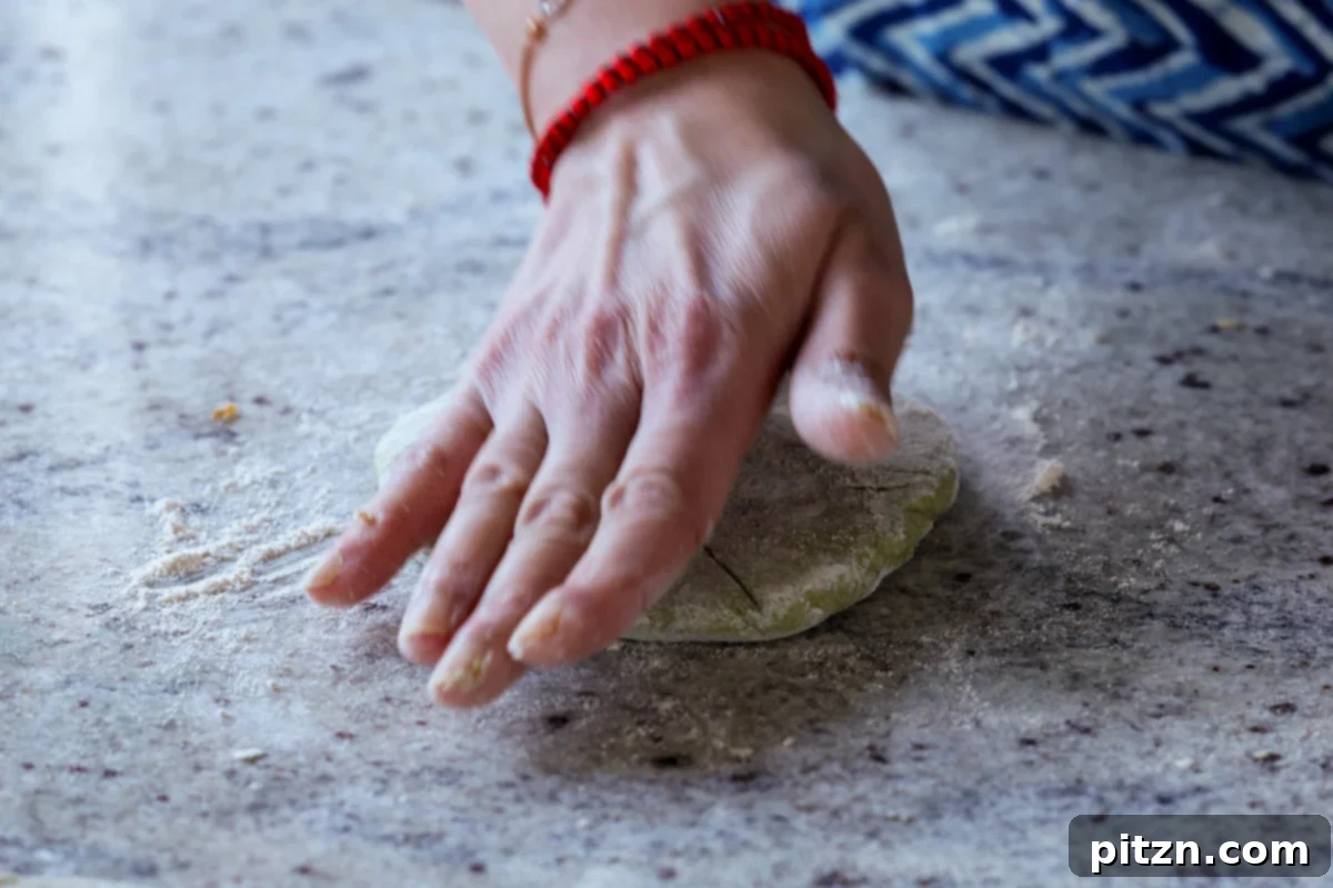 Yeast-Free Spinach Paratha Flatbread 31 Gently flattening the stuffed paratha with hands before using a rolling pin, to prevent tearing.