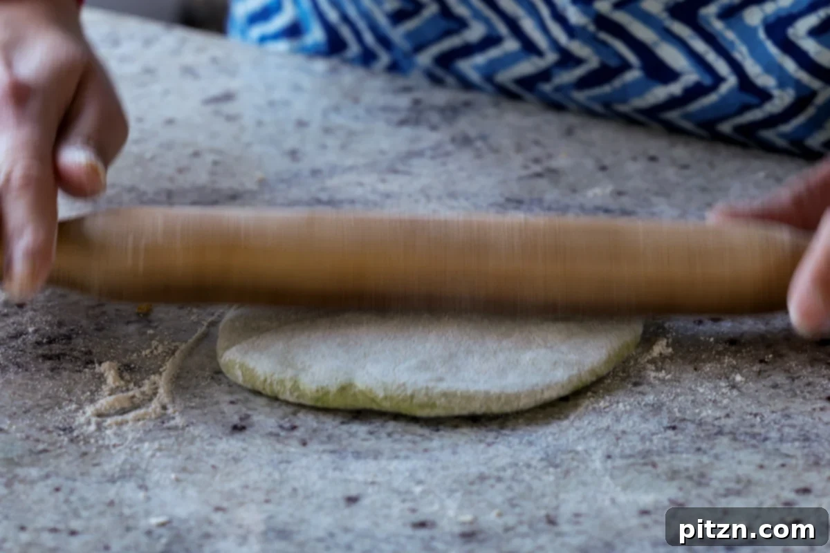 Yeast-Free Spinach Paratha Flatbread 32 Using a rolling pin to carefully roll out the stuffed paratha to its final thickness and diameter.